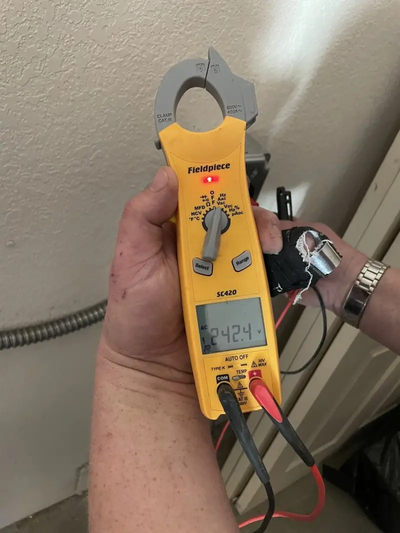 Voltage testing with clamp meter during Electrical Installation Services in Harris